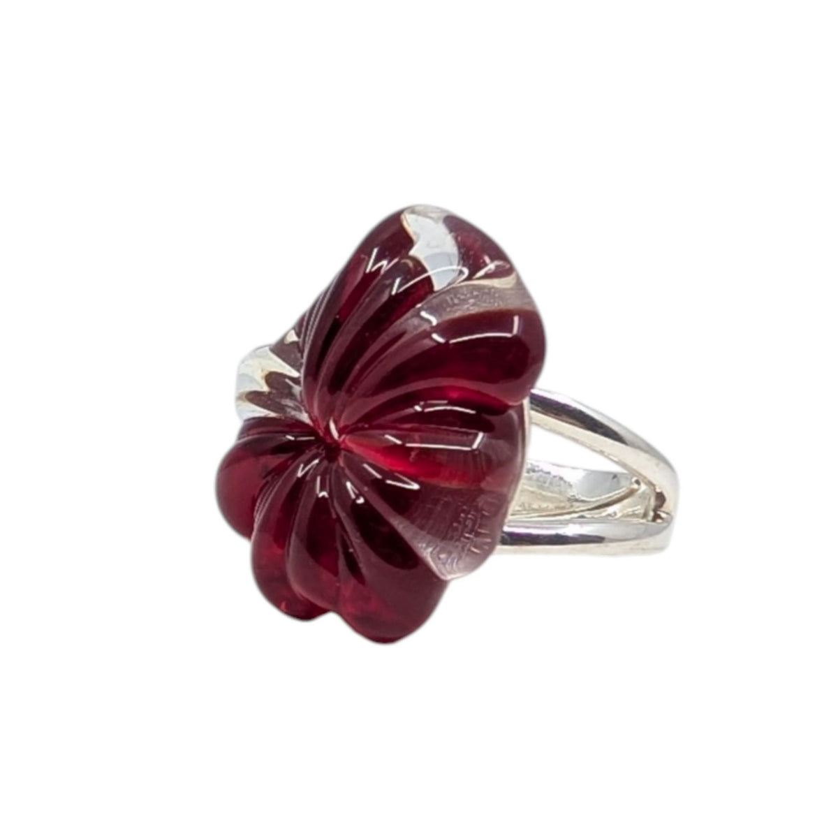 A silver ring featuring a sculpted, flower-like glass ring in deep burgundy red with white marbled streaks, set against a plain white background.