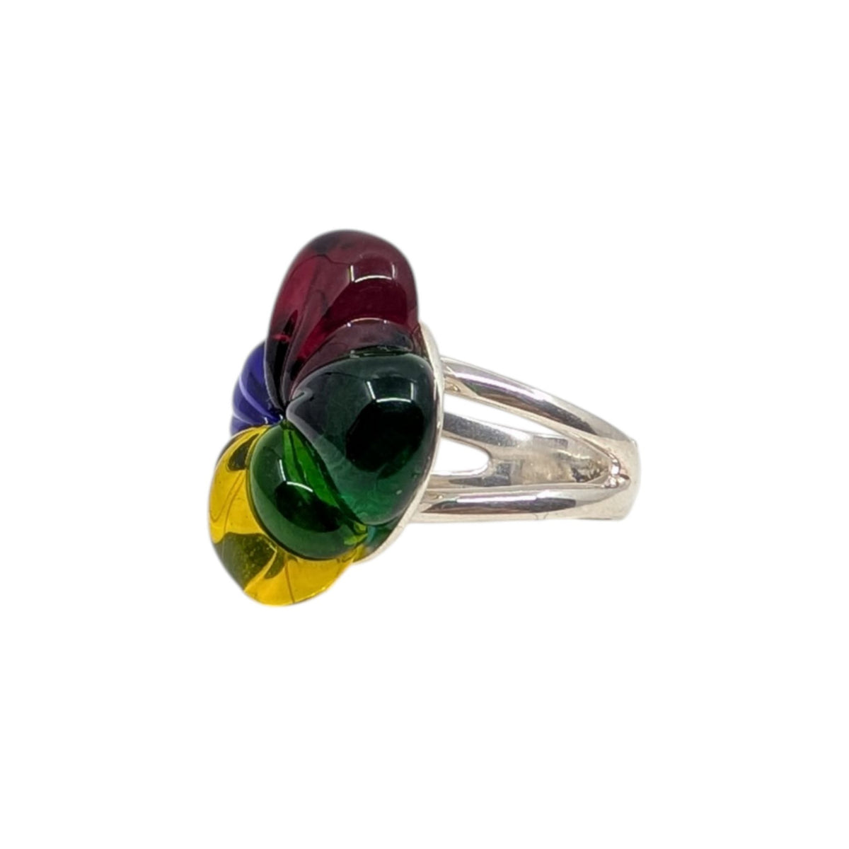A silver ring featuring a cluster of colorful, teardrop-shaped glass cabochons in red, purple, green, and yellow, set against a plain white background.