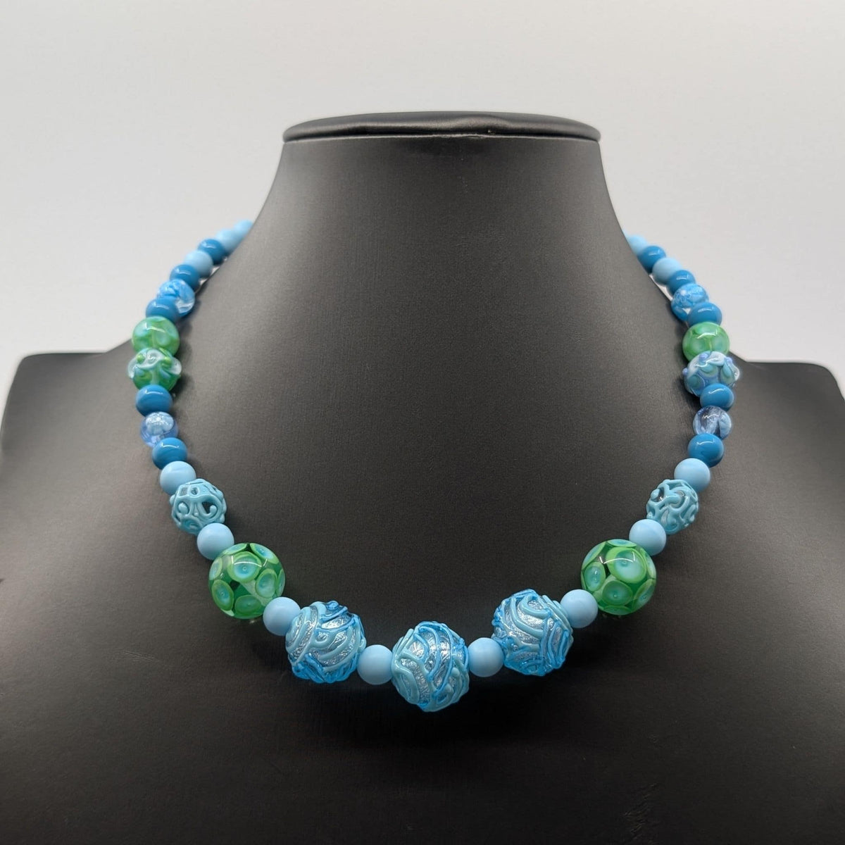 murano glass beads blue on a stanc.