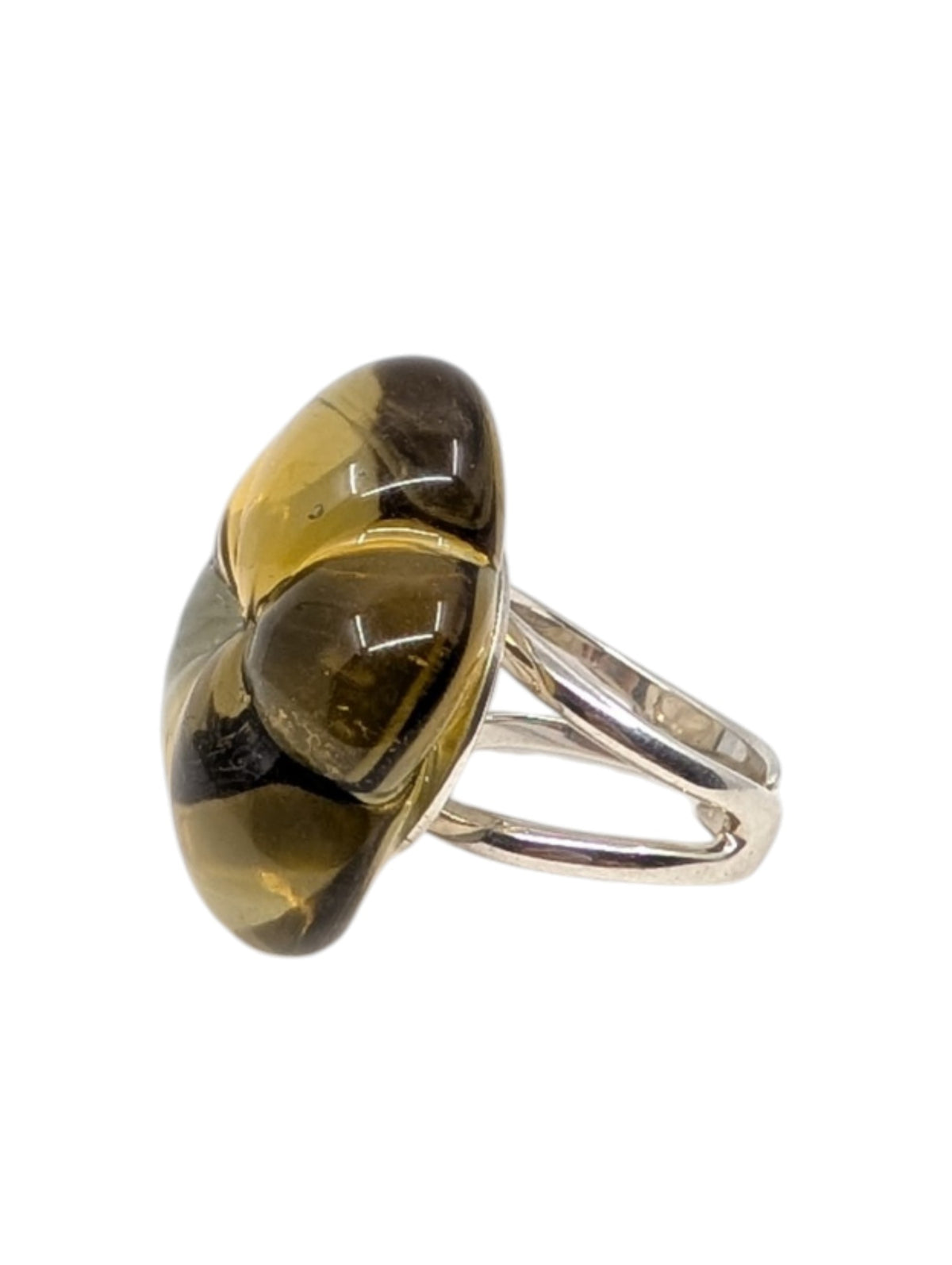 A silver ring featuring a large, organic-shaped resin cabochon with a marbled pattern of translucent olive green, amber yellow, and dark brown, set against a plain white background.