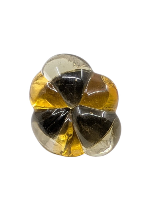 A single flower-shaped ring glass with four petals, featuring a gradient of clear amber yellow, shown on a plain white background.