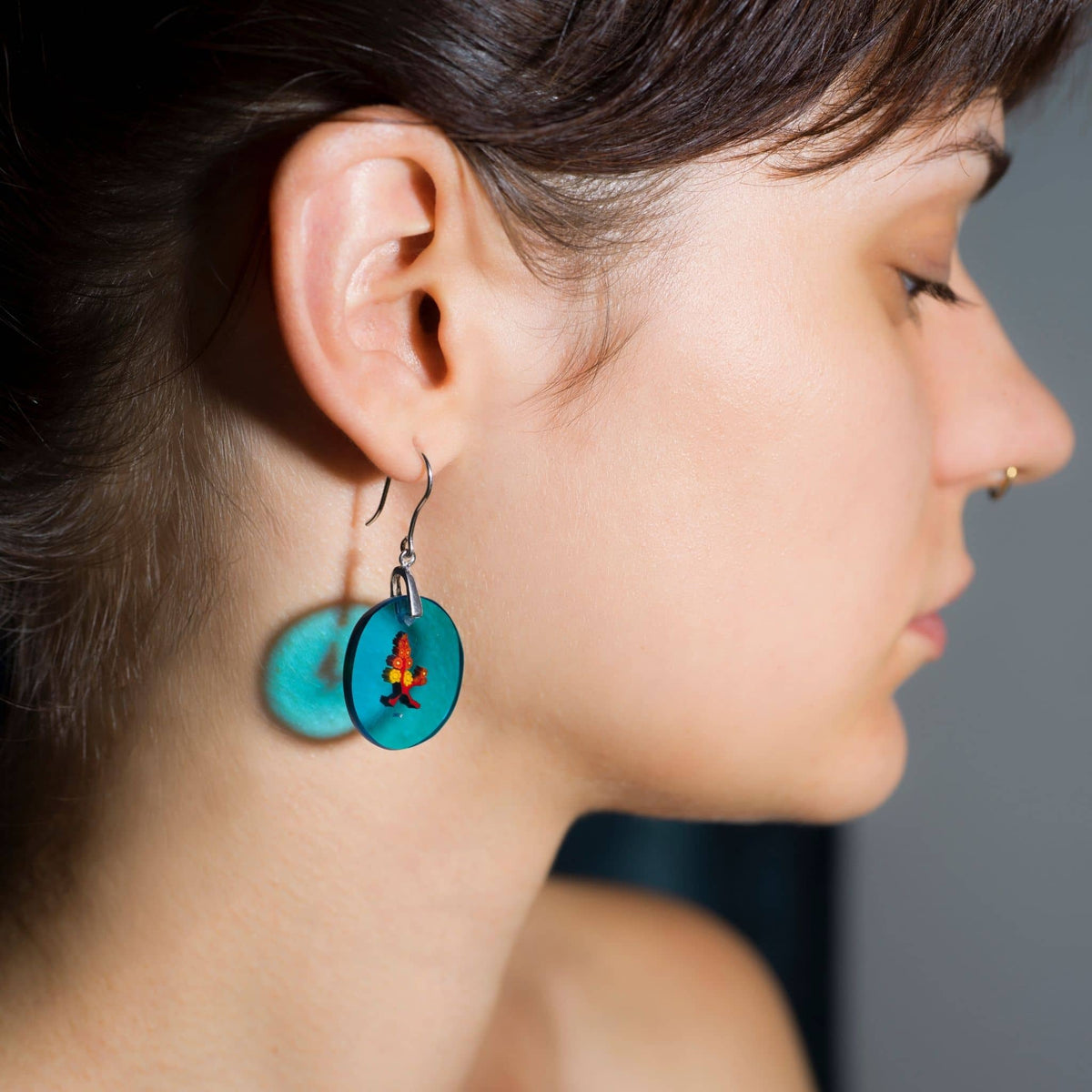 millefiori earrings with red flowers in murano glass on a model