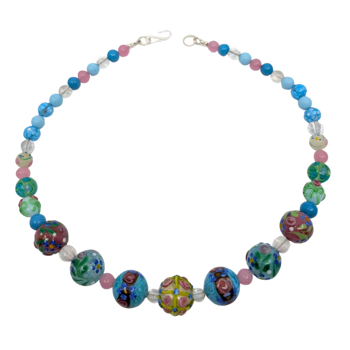 A beaded necklace featuring a mix of colorful glass beads, including blue, pink, green, and patterned lampwork beads, arranged in a circle on a white background.