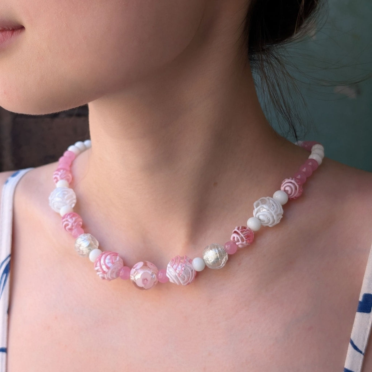 necklace on a neck with pink and silver and white glass beads